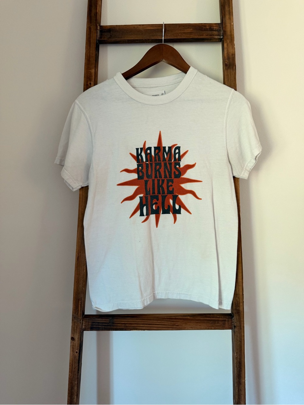 White Graphic Tee with Orange Sunburst and Black Text
